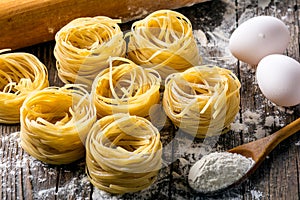 Pasta and ingredients on wooden background