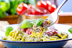 Pasta. Italian and Mediterranean cuisine. Pasta Fettuccine with tomato sauce basil leaves garlic and parmesan cheese. An old home