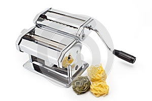 Pasta machine with fresh noodles isolated on white