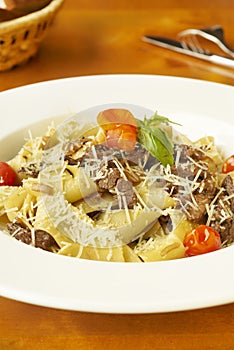 Pasta with meat, cherry tomatoes and cheese