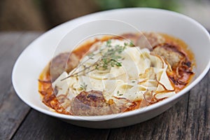 Pasta meatballs tomato sauce on wooden table