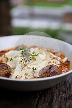 Pasta meatballs tomato sauce on wooden table