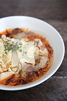 Pasta meatballs tomato sauce on wooden table