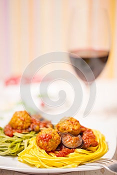 Pasta with meatballs, tomatoes and eggplant