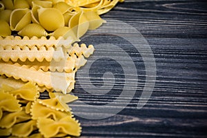 Pasta mix on wooden background