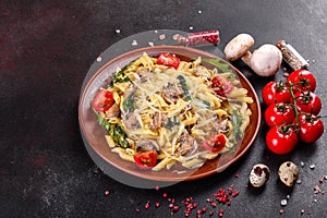 Pasta with mushrooms, cheese, spinach, rukkola and cherry tomatoes