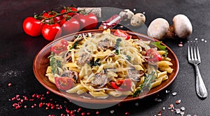 Pasta with mushrooms, cheese, spinach, rukkola and cherry tomatoes