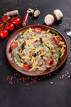 Pasta with mushrooms, cheese, spinach, rukkola and cherry tomatoes