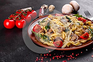 Pasta with mushrooms, cheese, spinach, rukkola and cherry tomatoes