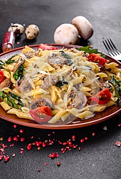 Pasta with mushrooms, cheese, spinach, rukkola and cherry tomatoes