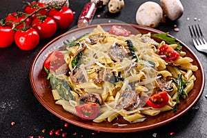 Pasta with mushrooms, cheese, spinach, rukkola and cherry tomatoes