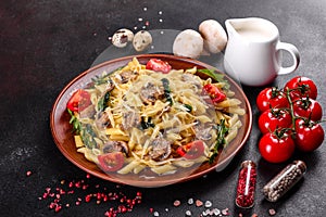 Pasta with mushrooms, cheese, spinach, rukkola and cherry tomatoes