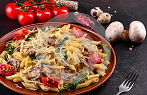 Pasta with mushrooms, cheese, spinach, rukkola and cherry tomatoes