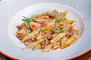 Pasta nautically with minced meat on wood table