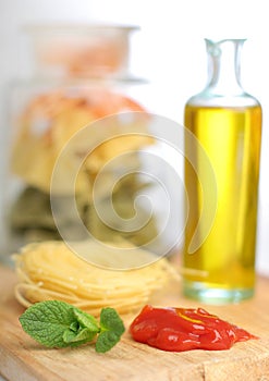 Pasta with oil bottle and ketchup