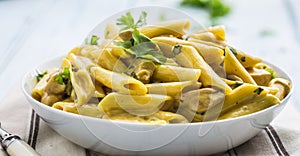 Pasta pene with chicken pieces mushrooms parmesan cheese sauce a photo