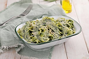 Pasta with pesto and cheese on an olive napkin