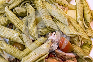 Pasta with pesto sauce and raw tomatoes