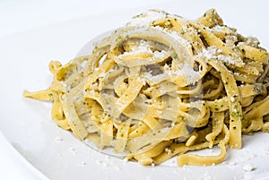 Pasta with pesto on white plate