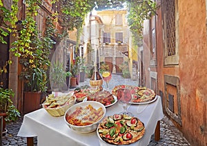 Pasta , pizza and homemade food arrangement in a restaurant Rome