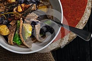 Pasta pizzoccheri with chinese cabbage, potato on dark background. italian traditional dish