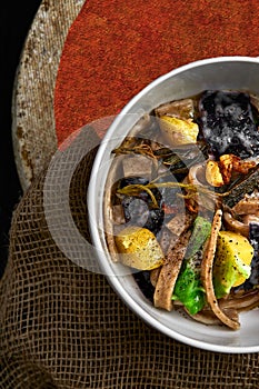 Pasta pizzoccheri with chinese cabbage, potato on dark background. italian traditional dish