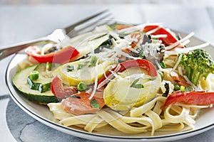 Pasta primavera with fettuccine and garden vegetables photo