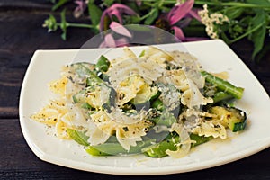 Pasta Primavera - it`s delicious, hearty and healthy dishes from South Italy. Wooden rustic background with flowers. Top