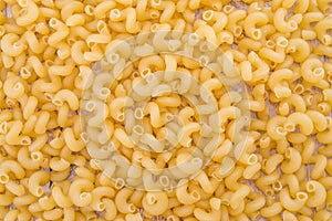 Pasta raw close up background. Delicious dry uncooked ingredient for traditional Italian cuisine dish. Textured variety shapes
