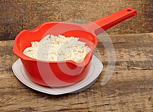 Pasta in red colander