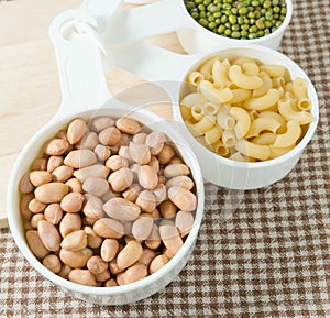 Pasta, Rice, Peanuts and Moong Beans in Measuring Cups