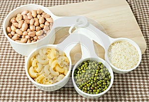 Pasta, Rice, Peanuts and Mung Beans in Measuring Spoons