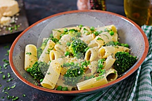 Pasta rigatoni with broccoli and green peas. Vegan menu.