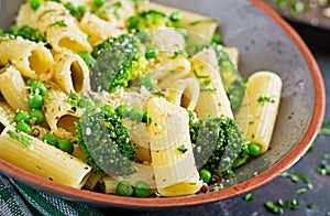 Pasta rigatoni with broccoli and green peas. Vegan menu
