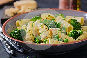 Pasta rigatoni with broccoli and green peas. Vegan menu.