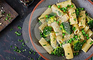 Pasta rigatoni with broccoli and green peas. Vegan menu. Dietary food. Flat lay.