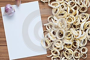 Pasta rings with blank paper, top view