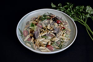 Pasta salad dish on dark background