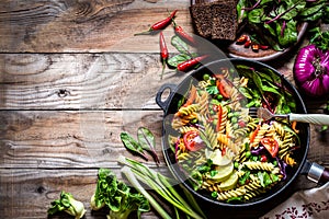 Pasta salad with fresh herbs spinach, vegetables and green peas