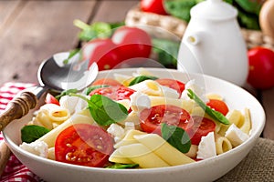 Pasta salad with fresh red cherry tomato and feta cheese. Italian cuisine