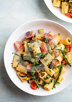 Pasta salad with grilled vegetables, zucchini, eggplant, asparagus and tomatoes.