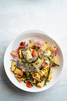 Pasta salad with grilled vegetables, zucchini, eggplant, asparagus and tomatoes.