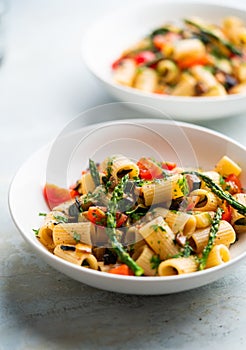 Pasta salad with grilled vegetables, zucchini, eggplant, asparagus and tomatoes.