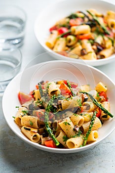 Pasta salad with grilled vegetables, zucchini, eggplant, asparagus and tomatoes.