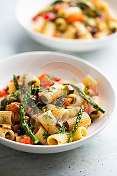 Pasta salad with grilled vegetables, zucchini, eggplant, asparagus and tomatoes.