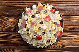 Pasta salad with mozzarella , olives and tomatoes