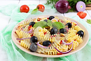 Pasta salad radiatori with chicken, black olives, blue onion, sweet pepper