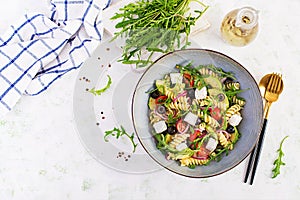 Pasta salad with tomato, avocado, black olives, red onions and cheese feta.