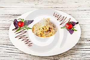 Pasta with sauce and tomatoes in a restaurant close-up. Italian pasta with microgreens on a white plate and copy space