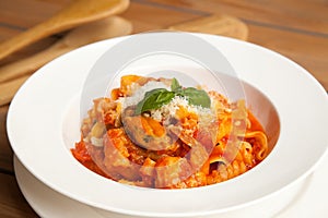Pasta with seafood in tomato sauce on a white dish. European cuisine
